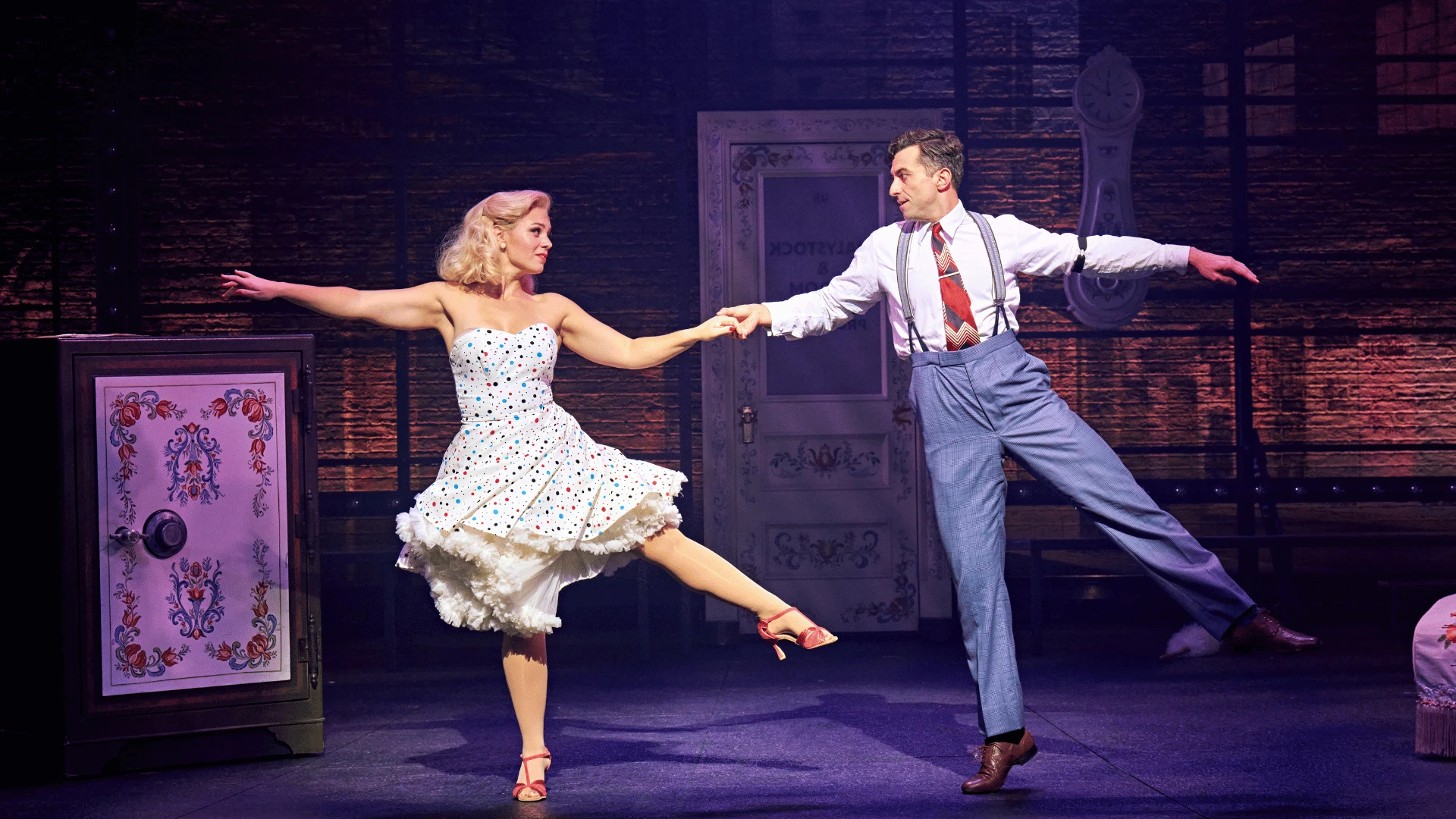 Joanna Woodward (Ulla) and Marc Antolin (Leo Bloom) dance with each other in The Producers at London's Garrick Theatre - credit Manuel Harlan